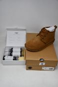 A pair of as new Ugg Neumel boots (UK 5) together with an Ugg care kit.