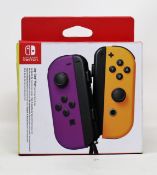 A boxed as new Nintendo Switch Joy-Con Controller Pair in Neon Purple/Neon Orange (P/N: HAC-JAQAA