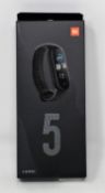 Five boxed as new Xiaomi Mi Band 5 Fitness Trackers in Black (Boxes sealed).