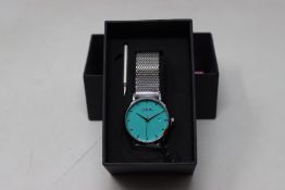A ladies boxed as new Coluri Watch in turquoise with a spare strap.