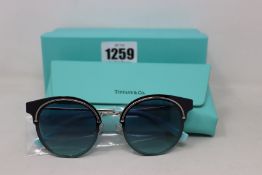 A pair of ladies boxed as new Tiffany & Co. Sunglasses (TF3061 60019S 64).