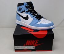 A pair of boxed as new Nike Jordan 1 High Sneakers in white and university blue (UK 11).