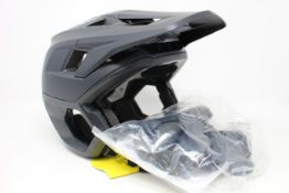 A boxed Fox Racing Dropframe Pro Helmet in black (M).
