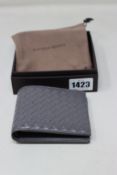 A boxed as new Bottega Veneta wallet in grey.