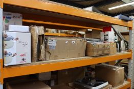 A shelf of kitchen appliances/items to include an air fryer, chopping boards and other related items