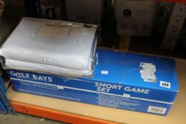 An as new Golf Bays Lite 3m x 3m impact screen and a Golf Bays short game set.