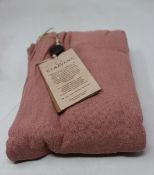 An as new Caravana Lan long vest in carmine red (One size - RRP £288).