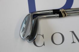Two Titleist Vokey SM8 chrome golf wedges.