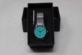 A ladies boxed as new Coluri Watch in turquoise with a spare strap.