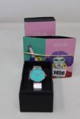 A ladies boxed as new Coluri Watch in turquoise with a spare strap.