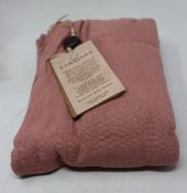 An as new Caravana Lan long vest in carmine red (One size - RRP £288).