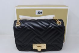 An as new Michael Kors Peyton medium quilted leather shoulder bag.