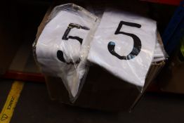 A large quantity of children's Nor-Folk white T-shirts with assorted numbers on front.