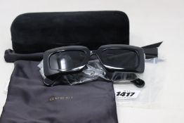 A pair of as new Gucci sunglasses.