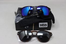 Two pairs of as new Oakley sunglasses; Latch and Gibston.