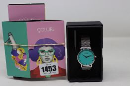 A ladies boxed as new Coluri Watch in turquoise with a spare strap.