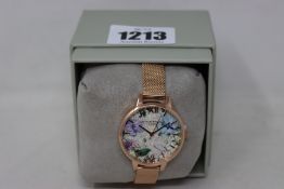 An as new boxed Olivia Burton Bejewelled floral silver glitter dial, 100% stainless steel rose