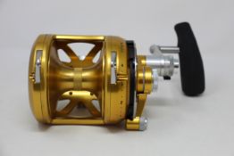 An as new Penn International 50VISX gold fishing reel.