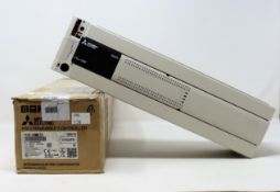 A boxed Mitsubishi MELSEC FX3U-128M programmable controller (box open, appears new)