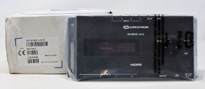 A boxed as new Creston 4 port HDMI distribution amplifier (PN: HD-MD4X1-4K-E) (Box damaged).