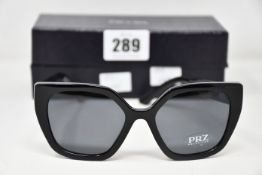 A pair of as new Prada sunglasses.