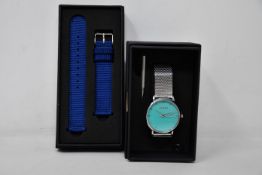 A ladies boxed as new Coluri Watch in turquoise with a spare strap.