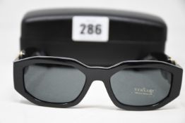 A pair of as new Versace sunglasses.