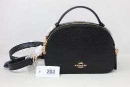 An as new Coach 1589 Serena black grainy leather satchel crossbody handbag.