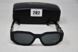 A pair of as new Versace sunglasses.