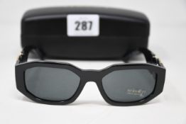 A pair of as new Versace sunglasses.