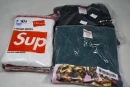 An as new Supreme Lovers Tee (L), Supreme The North Face One World Tee (L) and pack of four
