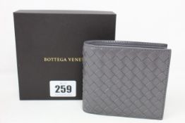 A boxed as new Bottega Veneta wallet in grey.