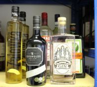 Eight bottles of assorted spirits to include Smirnoff vodka, The Three Graces Roses gin, Cotswolds