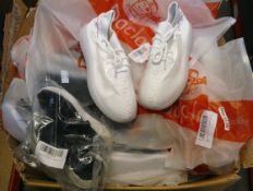 A large box of children's Daclay trainers in various sizes and colours.