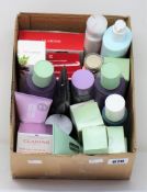 A box of assorted Clarins and Clinique products to include moisture milk, day creams, double