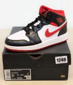 A pair of youths as new Nike Air Jordan 1 Mid (UK 3).