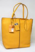 An as new TOD'S shopping tote SFOD Piccola bag with dust cover.