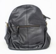 An as new Hannah common natural black leather back pack bag with dust cover.