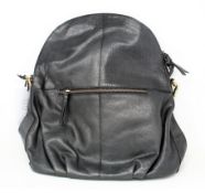 An as new Treats Hannah common natural black leather back pack bag with dust cover.