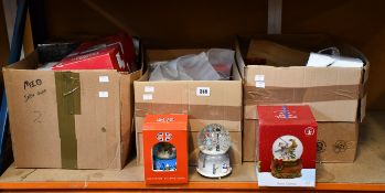 Three boxes of assorted boxed/unboxed snow globes.