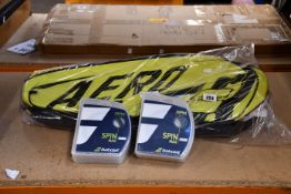 A Babolat RHX12 Pure Aero Tennis Bag in black and yellow and twelve Babolat RPM Rough String Sets (