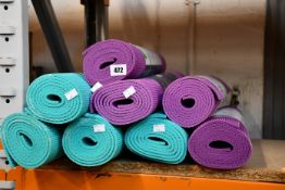 Eight Gaiam Premium Yoga mats.