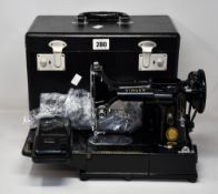 A pre-owned Vintage Singer 222K sewing machine with accessories and carry case.