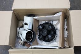 A box of pre-owned surveillance equipment to include; a 4x5 MPWDR Light catcher 2.8mm camera only, a
