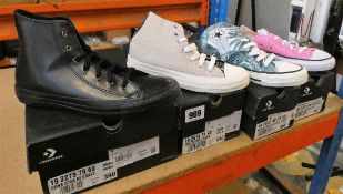 Four pairs of Converse footwear.