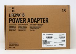 A boxed as new Physio-Control LIFEPAK 15 DC Power Adapter (P/N: 11140-000074) (Box opened, some