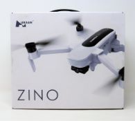 A boxed as new Hubsan Zino Folding Quadcopter Drone (UK plug adapter required) (Damage to box).
