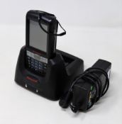A pre-owned Honeywell Dolphin 60s Mobile Computer Barcode Scanner with cradle and power supply.