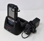 A pre-owned Honeywell Dolphin 60s Mobile Computer Barcode Scanner with cradle and power supply.