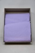 A Tekla 260 x 220cm cotton percale double bedding set in lavender.